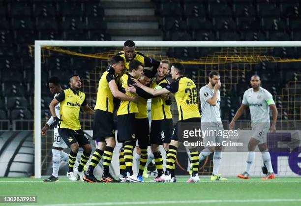 Christian Fassnacht of Young Boys celebrates with teammates after scoring their team's first goal during the UEFA Europa League Round of 32 match...