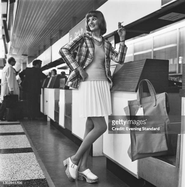Fashion model wearing a Madras blazer at the airport, UK, 3rd July 1972.
