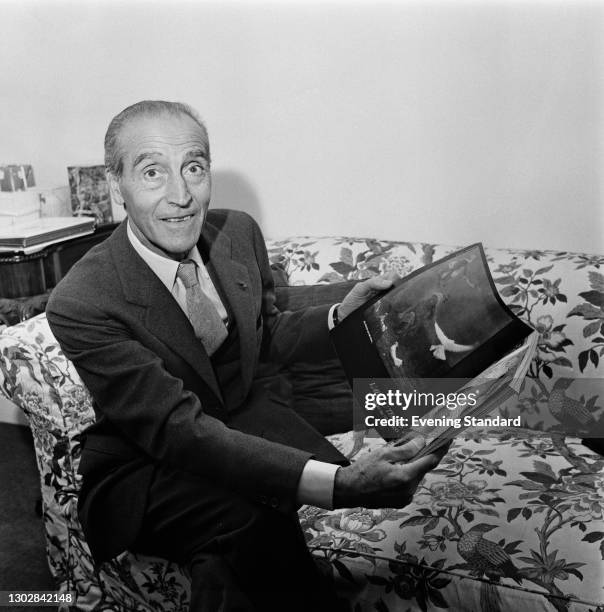 Robert Ricci , who founded the fashion house Nina Ricci with his mother, couturier Maria 'Nina' Ricci, UK, 5th October 1972. He is reading a...