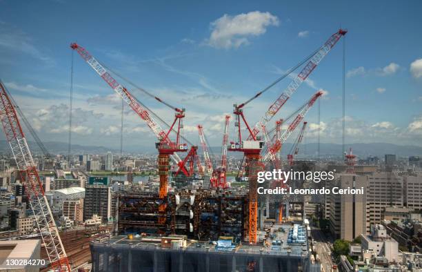 construction cranes at work - crane construction machinery stock-fotos und bilder