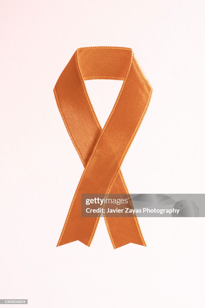 Peach Awareness Ribbon On Pink Background