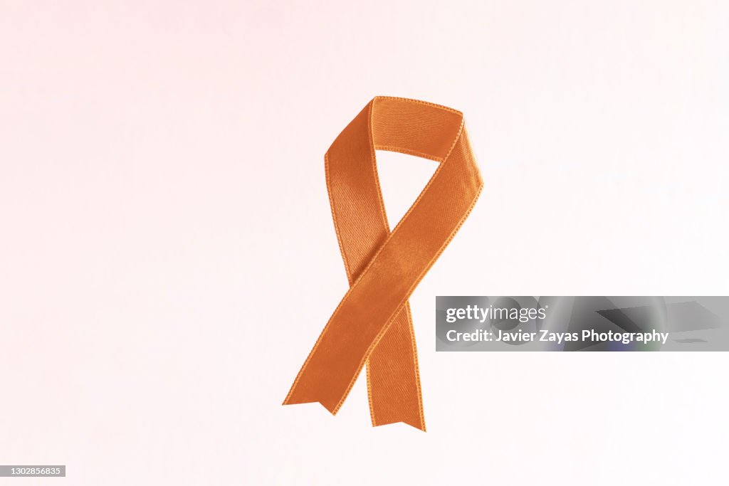 Peach Awareness Ribbon On Pink Background