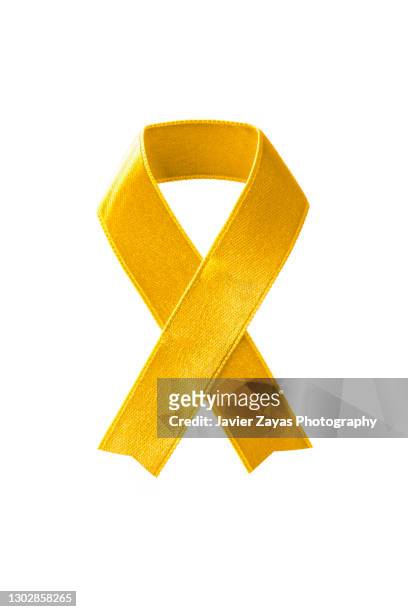 gold awareness ribbon on white background - childhood cancer stock pictures, royalty-free photos & images