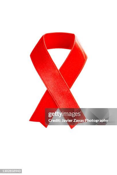 red awareness ribbon on white background - human trafficking stock pictures, royalty-free photos & images