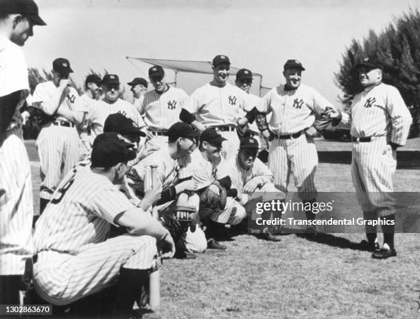 Baseball manager Joe McCarthy , of the New York Yankees, takls with his players during spring training, St Petersburg, Florida, 1937.