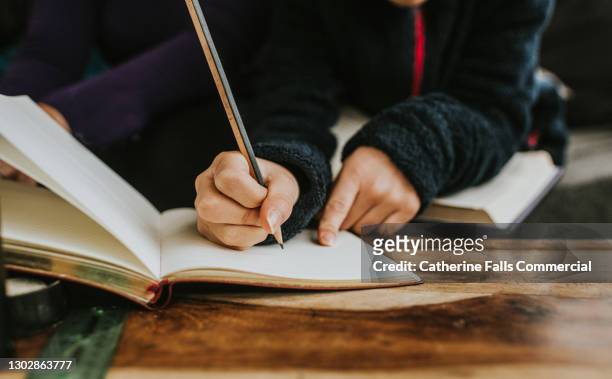 close-up of a child writing into a jotter - spelling fotografías e imágenes de stock