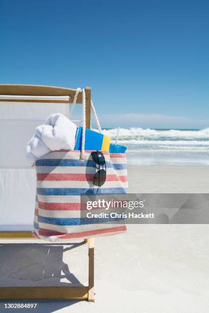 bag on beach chair - beach bag stock pictures, royalty-free photos & images