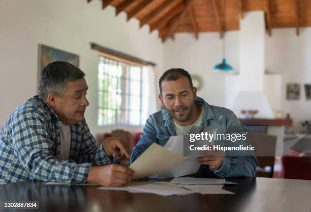 landowner talking to his overseer at a farm while checking the books - farmers insurance stock pictures, royalty-free photos & images