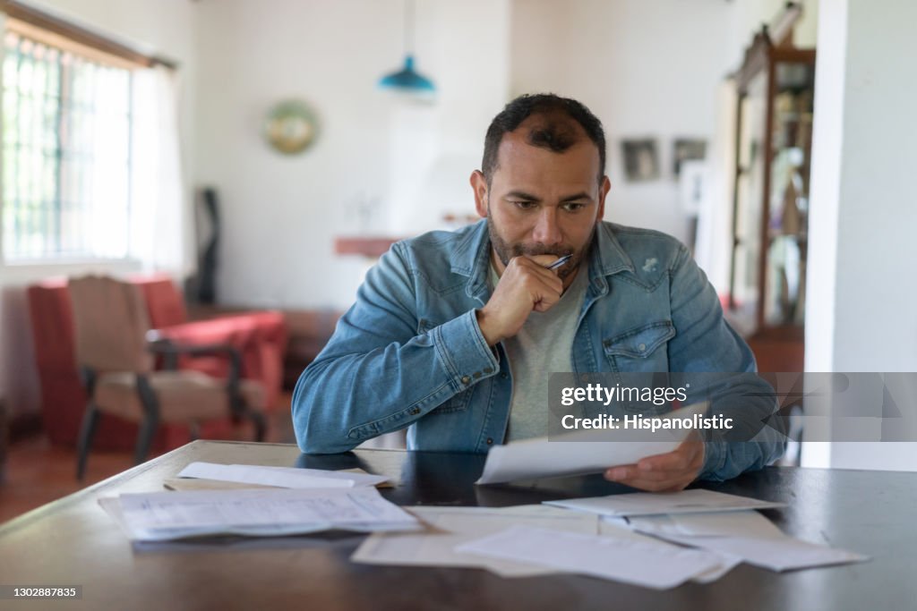 Low income man checking his home finances and looking worried