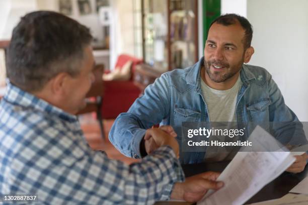 farmers closing a deal with a handshake at a farm - landlord stock pictures, royalty-free photos & images