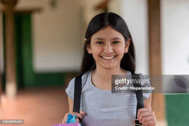 girl looking very happy to go back to school - poverty girl stock pictures, royalty-free photos & images