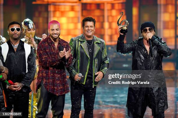 Wisin is presented with Lo Nuestro Excellence Award with Felix Ortiz of Zion y Lennox, Maluma, and Carlos Vives onstage during Univision's 33rd...