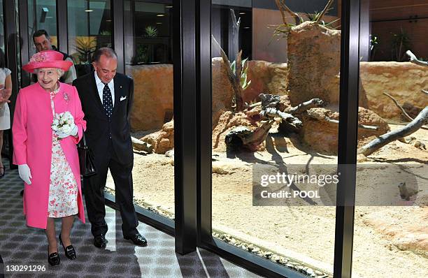 Britain's Queen Elizabeth II inspects the meerkat enclosure with chairman Tony Beddison as she officially opens the new Royal Children's Hospital,...