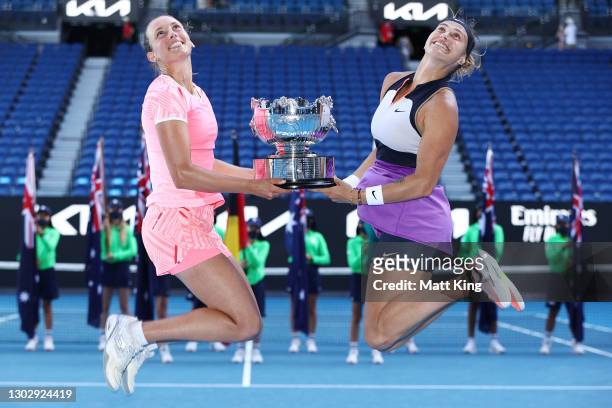 Elise Mertens of Belgium and Aryna Sabalenka of Belarus pose with the championship trophy after winning their Women's Doubles Final match against...