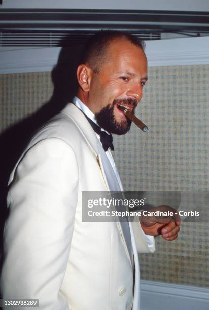 Actor Bruce Willis smoking a cigar at the 'Pulp Fiction' party during the 47th International Film Festival, Cannes, France, May 1994.