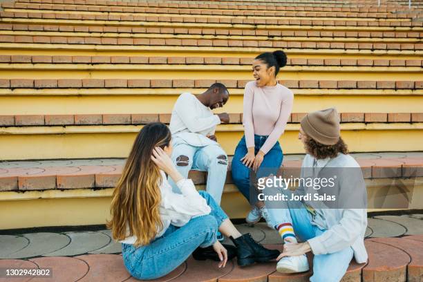 group of teenegers hanging out - boy and girl talking stock pictures, royalty-free photos & images