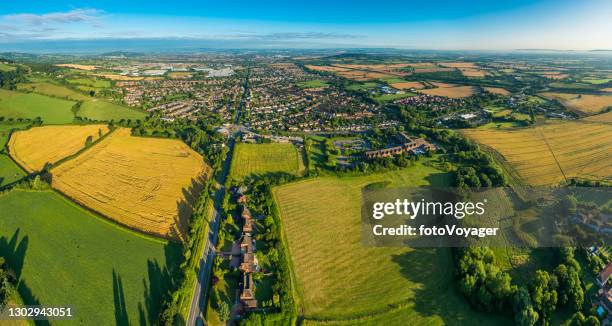 aerial panorama over town and country green fields suburban homes - gloucestershire stock pictures, royalty-free photos & images