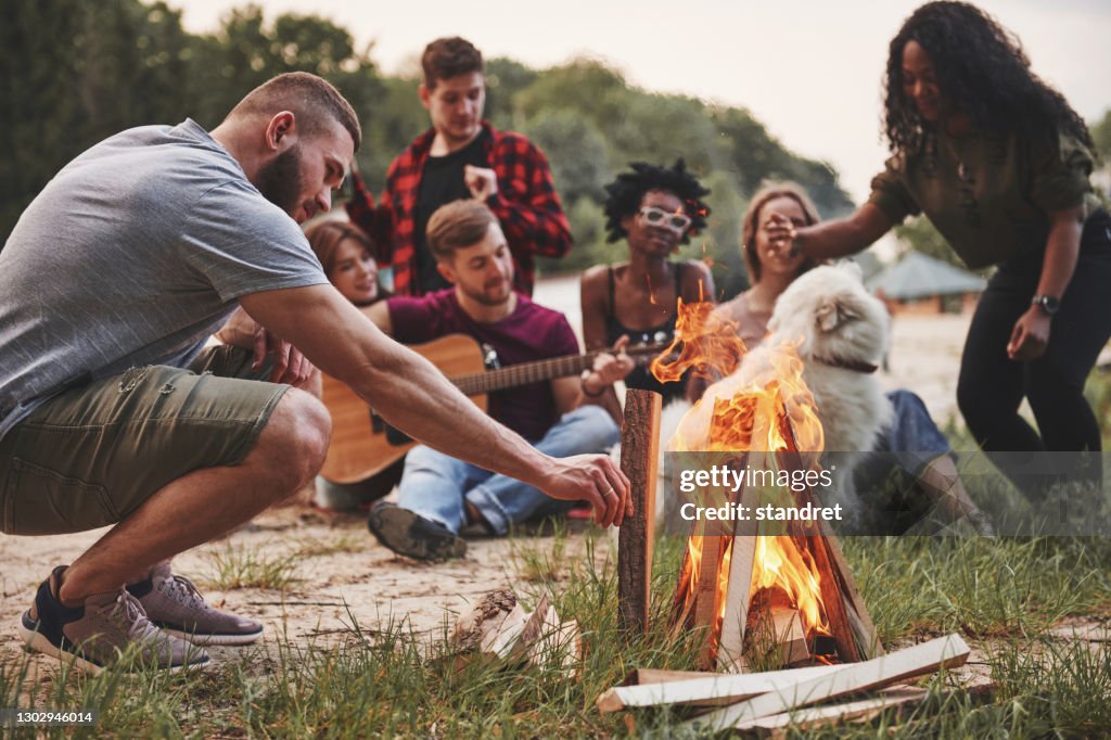 Summertime happiness. Group of people have picnic on the beach. Friends have fun at weekend time
