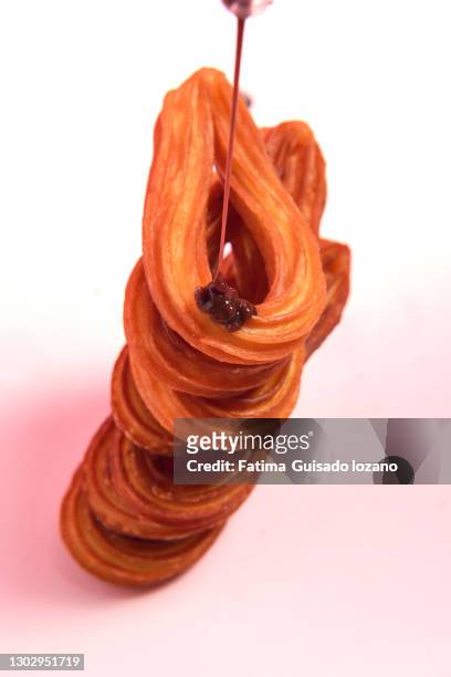 still life of churros with chocolate on a pink background - chocolate con churros stock pictures, royalty-free photos & images