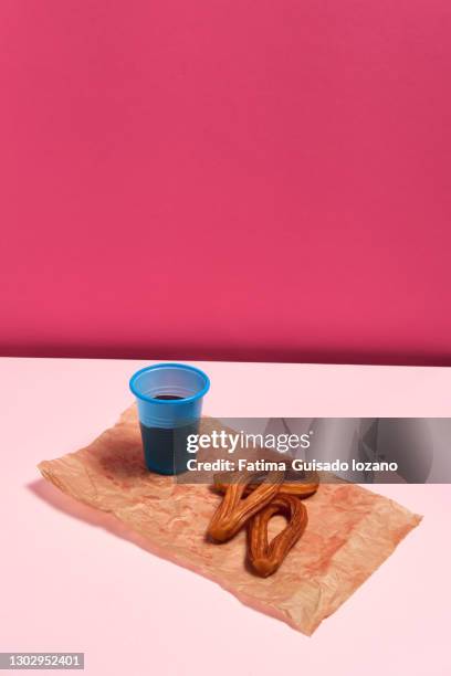 still life of churros with chocolate on a pink background - chocolate con churros stock pictures, royalty-free photos & images