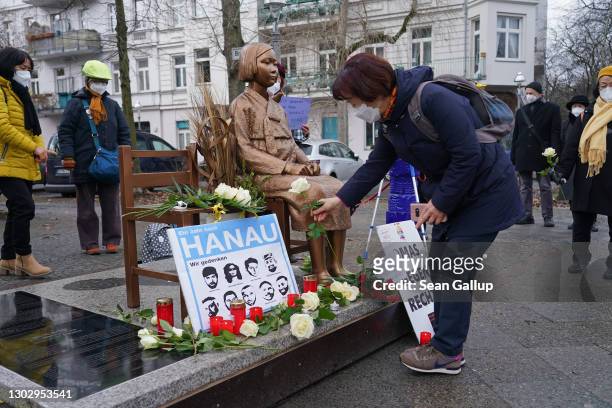 People gather at a memorial to World War II Korean "comfort women" to commemorate the first anniversary of the mass shooting in Hanau on February 19,...