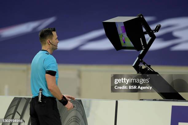 Referee Ivan Kruzliak consulting the VAR during the UEFA Europa League match between Lille OSC and Ajax at Stade Pierre Mauroy on February 18, 2021...