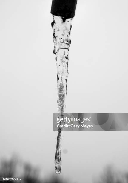 water frozen from pipe in winter - frozen pipes stock pictures, royalty-free photos & images