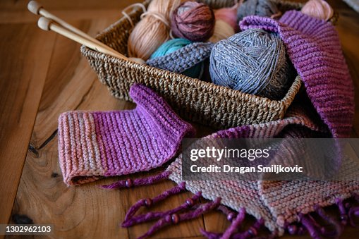 Accessories for knitting in basket ( yarn, needles) and scarf