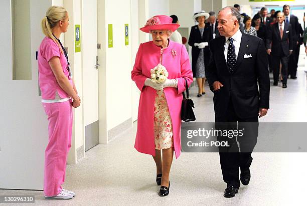 Britain's Queen Elizabeth II accompanied by chairman Tony Beddison inspects the new Royal Children's Hospital, meeting with a small group of ill...