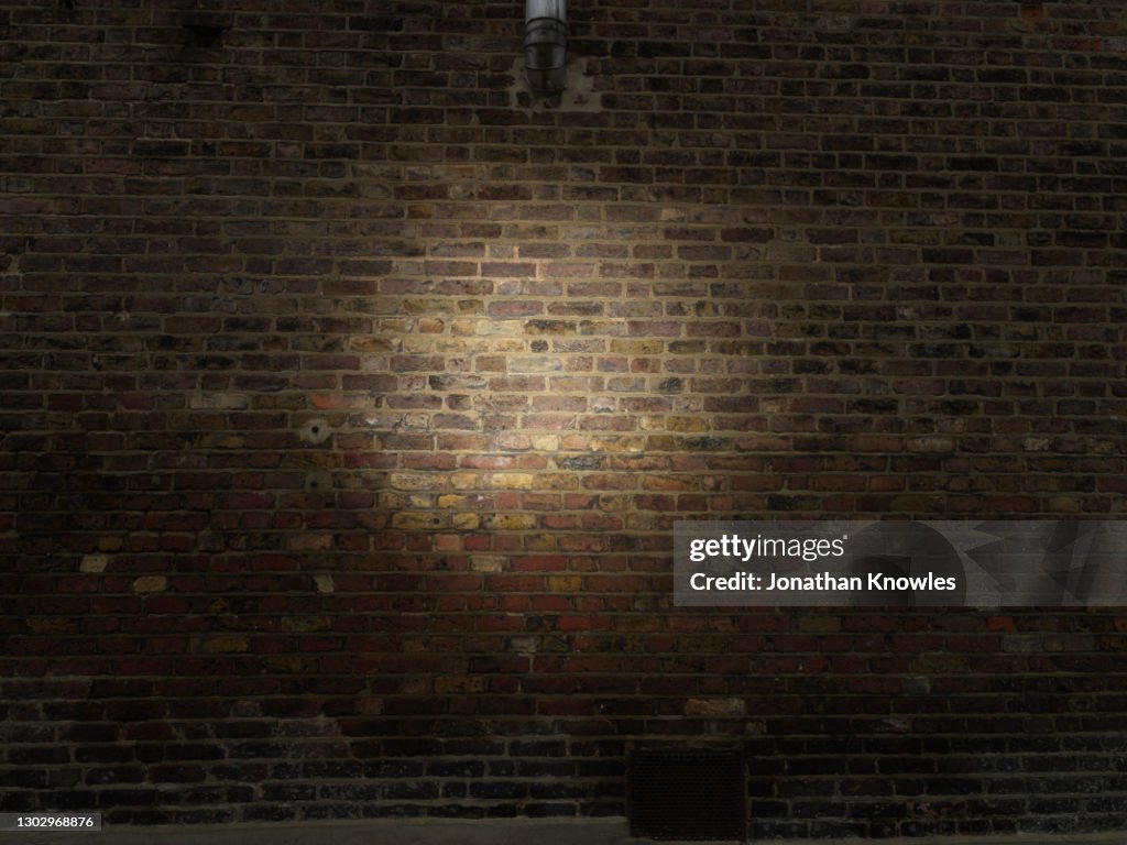 Spotlight on brick wall