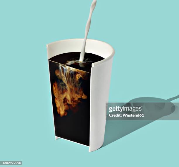 cross section of milk mixing with coffee inside disposable cup - coffee drink splash stock pictures, royalty-free photos & images
