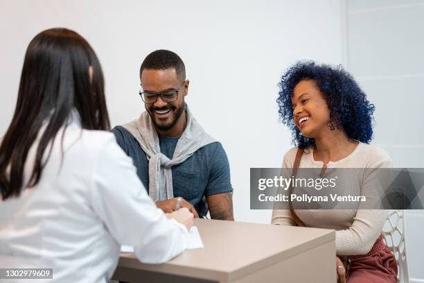 psychologist attending a young couple - infertility doctor stock pictures, royalty-free photos & images