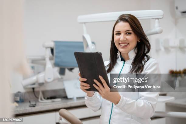 dentist uses digital table in dental office - digitizer imagens e fotografias de stock