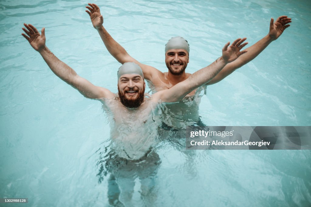 Males Stretching Out Arms And Enjoying Swimming Pool Freedom