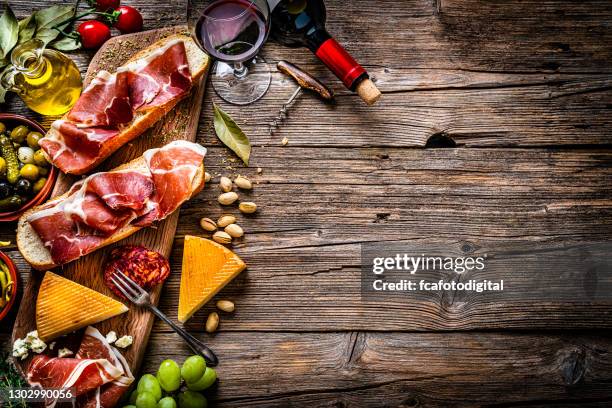 spanish food: iberico ham sandwich, spanish bocadillo de jamon iberico and red wine - food table edge stock pictures, royalty-free photos & images