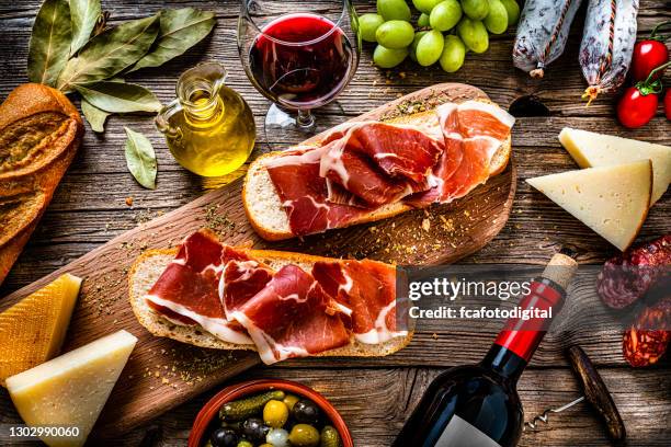 spanish food: iberico ham sandwich, spanish bocadillo de jamon iberico and red wine - jamón serrano stock pictures, royalty-free photos & images