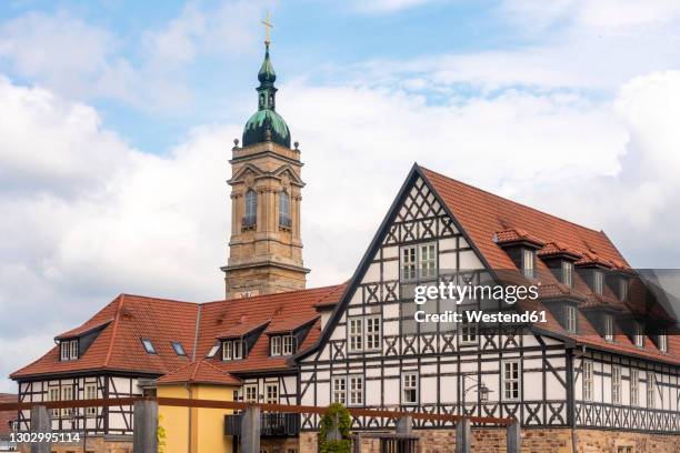 half-timbered houses at luther square near st george church against cloudy sky in eisenach, germany - eisenach stock-fotos und bilder