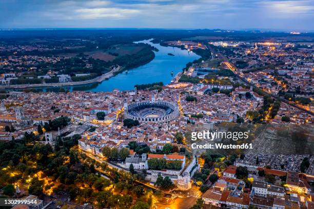france, provence-alpes-cote dazur, arles, aerial view of arles amphitheatre and surrounding buildings at dusk - arles stock pictures, royalty-free photos & images