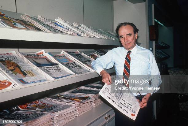 Portrait of Australian-born American media executive Rupert Murdoch as he poses, beside a display rack of periodicals he owns, in his office at the...