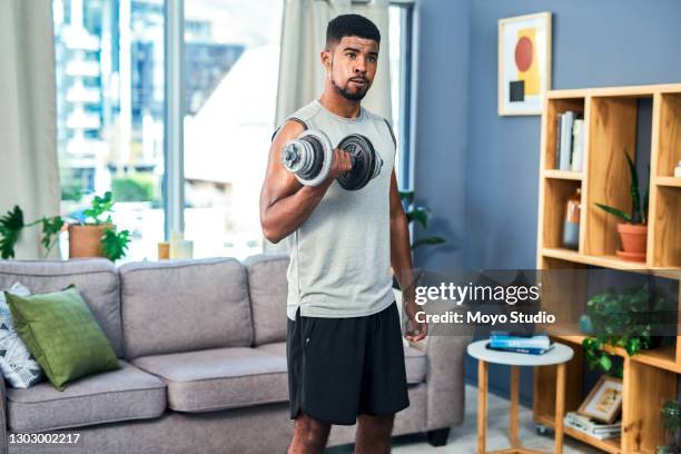 becoming fiercer and stronger by the day - man dumbbell stock pictures, royalty-free photos & images