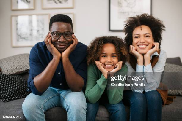 portrait of an african american family at home - african american history stock pictures, royalty-free photos & images