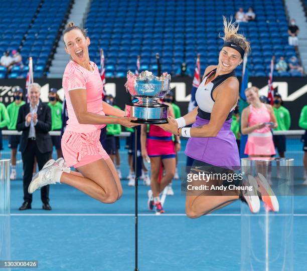 Elise Mertens of Belgium and Aryna Sabalenka of Belarus pose with the championship trophy after winning their Women's Doubles Final match against...