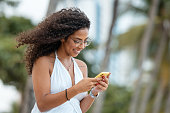 Young woman with smart phone on the beach