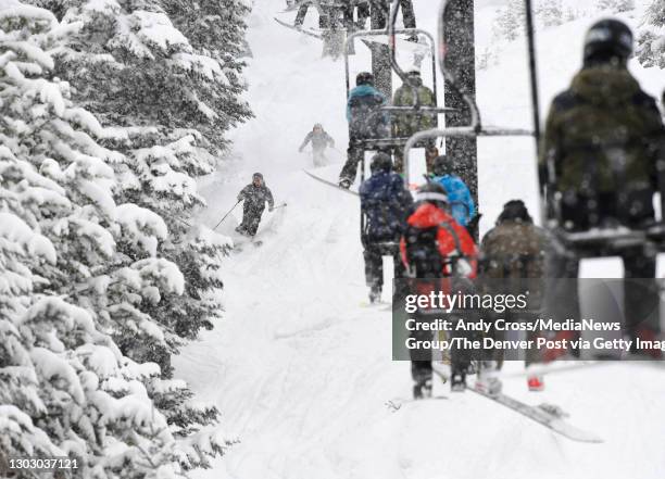 Pair of skiers negotiate 10-inches of fresh powder on the Sleepy Hollow run underneath the Challenger lift at the Mary Jane ski area at Winter Park...