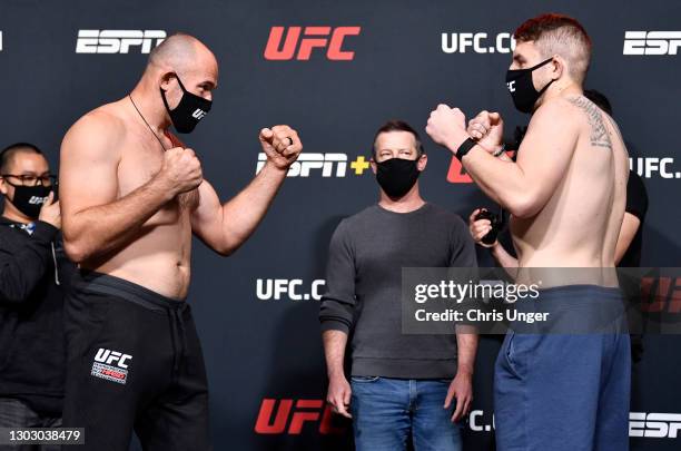 Opponents Aleksei Oleinik of Russia and Chris Daukaus face off during the UFC weigh-in at UFC APEX on February 19, 2021 in Las Vegas, Nevada.