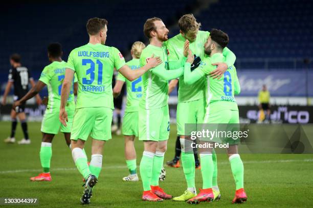 Renato Steffen of VfL Wolfsburg celebrates with teammates Yannick Gerhardt, Maximilian Arnold and Wout Weghorst after scoring their team's first goal...