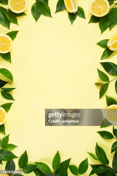 lemons on yellow background - lemon leaf stock pictures, royalty-free photos & images