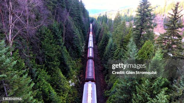 aerial image of freight train in the rocky mountains - rocky mountains north america stock-fotos und bilder