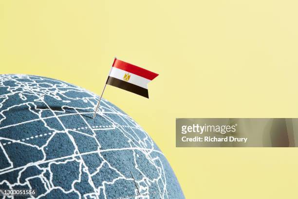 a world globe with an egyptian flag pin showing egypt - egypt flag stock pictures, royalty-free photos & images