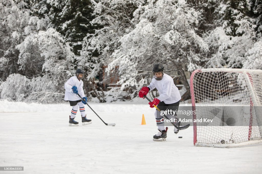 Ice-hockey players practice on an outdoor ice rink
